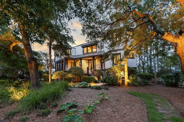 3121 Marshgate Dr, Seabrook Island, SC 29455 - view of front facade featuring covered porch, a metal roof, and a standing seam roof