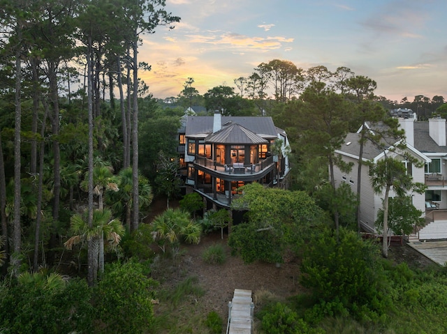 3121 Marshgate Dr, Seabrook Island, SC 29455 - back of house featuring a metal roof, a deck, stairs, and a chimney