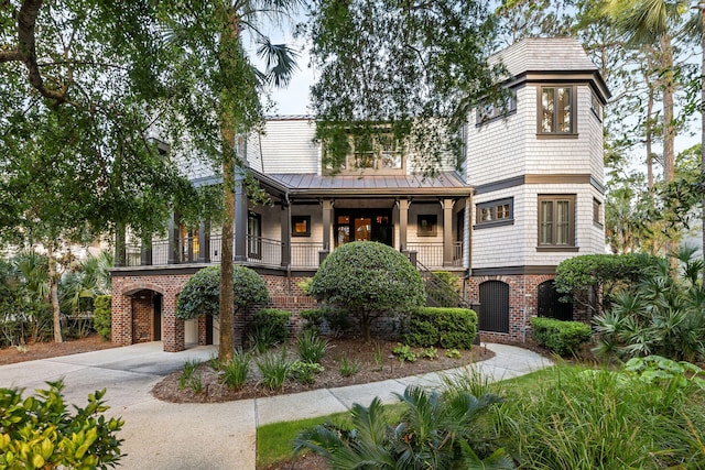 3121 Marshgate Dr, Seabrook Island, SC 29455 - view of front of property with driveway, brick siding, a standing seam roof, a metal roof, and covered porch