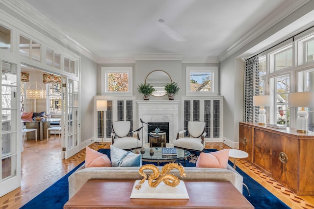 living area featuring a wealth of natural light, a fireplace, crown molding, and french doors