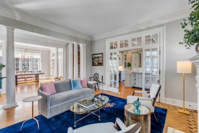 living area featuring baseboards, decorative columns, and crown molding