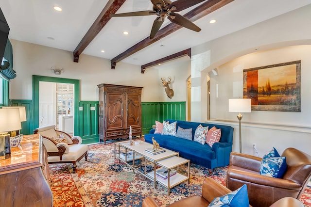 living area with recessed lighting, beam ceiling, and wainscoting