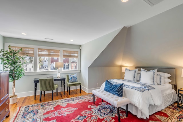 bedroom featuring visible vents, baseboards, wood finished floors, and recessed lighting