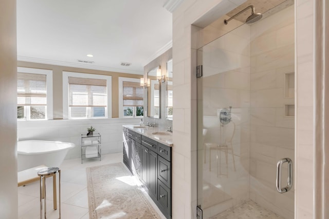 full bath with tile walls, a shower stall, ornamental molding, and a sink