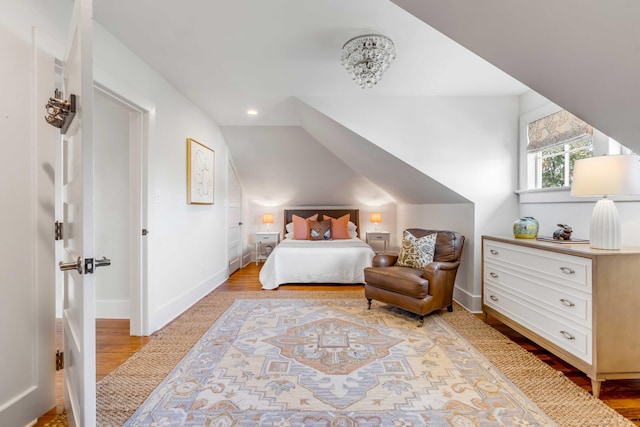 bedroom with light wood finished floors, baseboards, vaulted ceiling, and recessed lighting