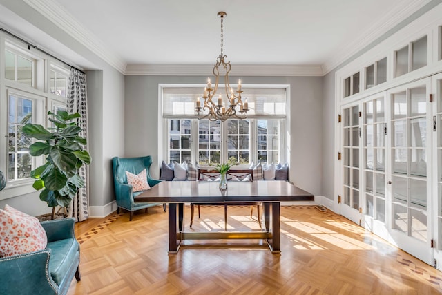 dining space featuring an inviting chandelier, baseboards, and ornamental molding