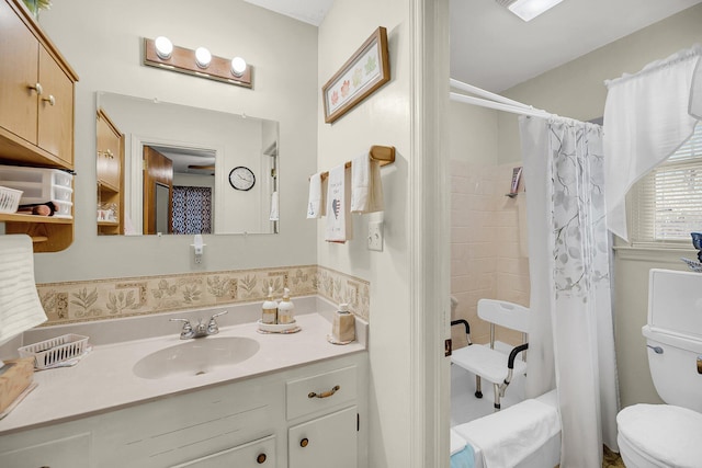 bathroom featuring toilet, shower / bath combo, and vanity