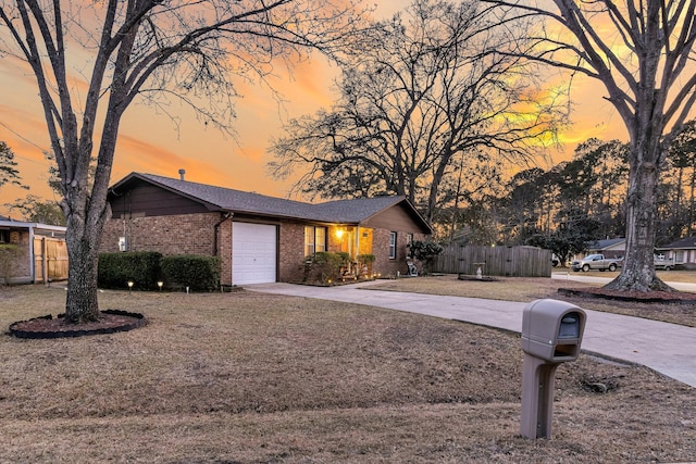 view of front of home with fence, driveway, roof with shingles, an attached garage, and brick siding