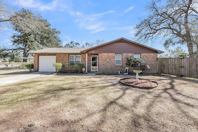 ranch-style house with brick siding, fence, a front yard, driveway, and an attached garage