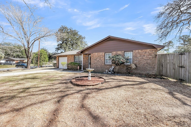 ranch-style home with brick siding, driveway, a garage, and fence