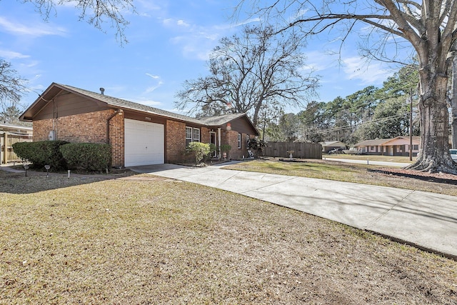 view of front of property featuring brick siding, a front lawn, fence, a garage, and driveway