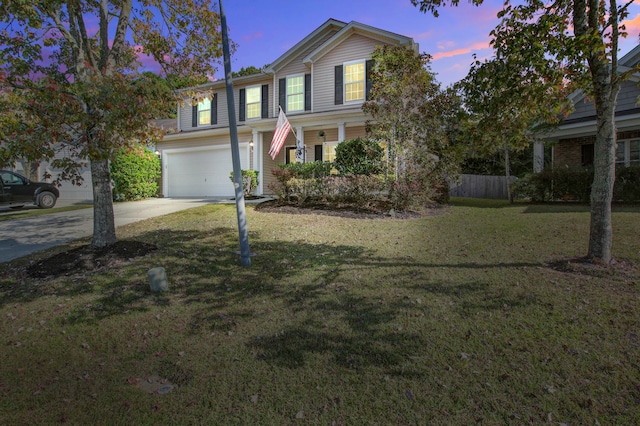 view of front property featuring a yard and a garage