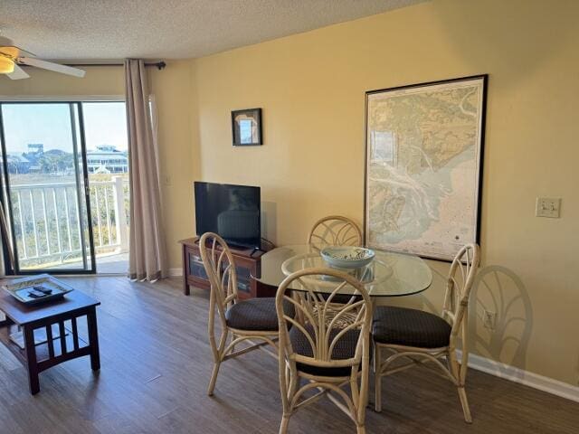 dining space with a textured ceiling, hardwood / wood-style flooring, and ceiling fan