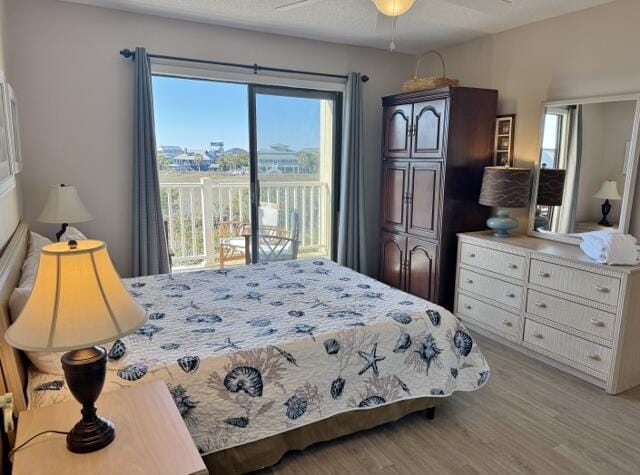 bedroom with access to outside, ceiling fan, and light wood-type flooring