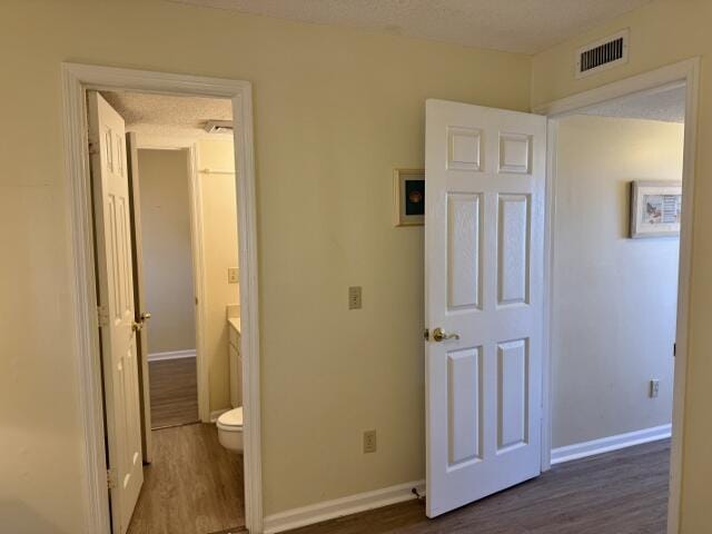 corridor with dark hardwood / wood-style floors