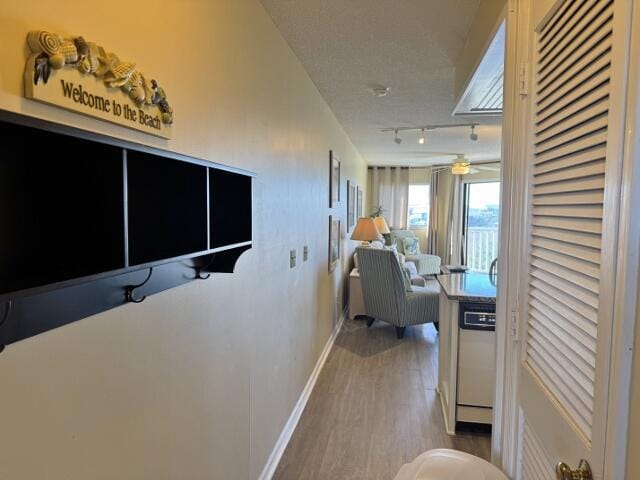 corridor with hardwood / wood-style floors