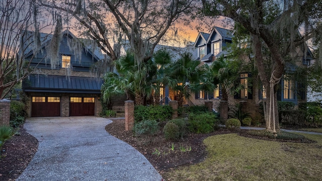 view of front of house featuring a garage and a balcony