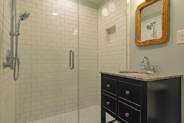 full bath with a shower stall and vanity