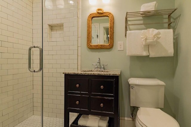 full bath with toilet, a shower stall, and a sink