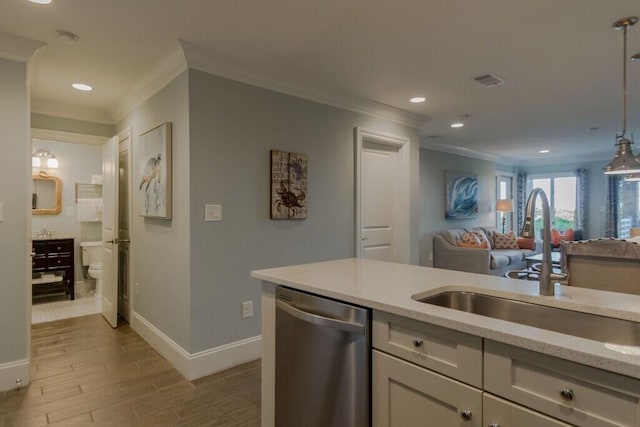 kitchen featuring a sink, light wood-style floors, crown molding, and dishwasher