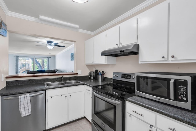 1120 Hidden Cove Dr Unit I, Mount Pleasant, SC 29464 - kitchen featuring appliances with stainless steel finishes, under cabinet range hood, crown molding, dark countertops, and white cabinetry