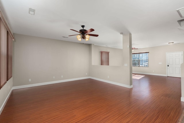 empty room featuring ceiling fan and dark hardwood / wood-style flooring