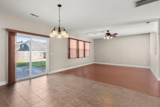 spare room with tile patterned flooring and ceiling fan with notable chandelier