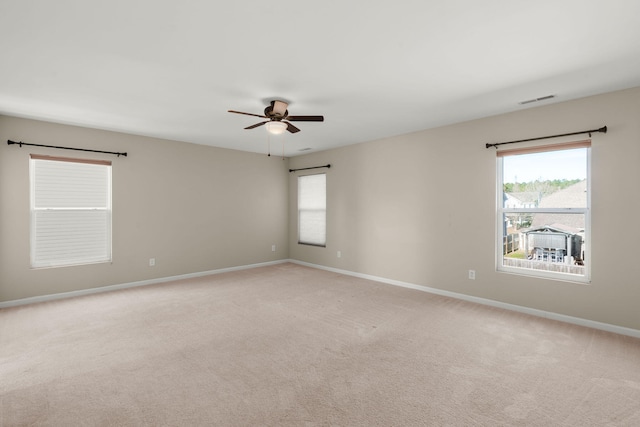 carpeted empty room featuring ceiling fan