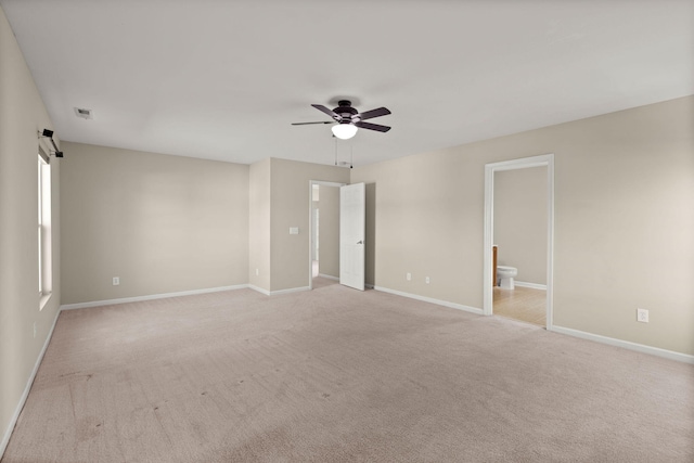 carpeted spare room featuring ceiling fan