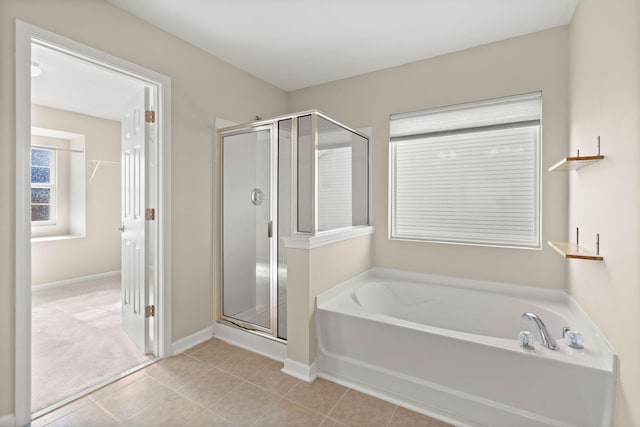 bathroom featuring tile patterned flooring and independent shower and bath