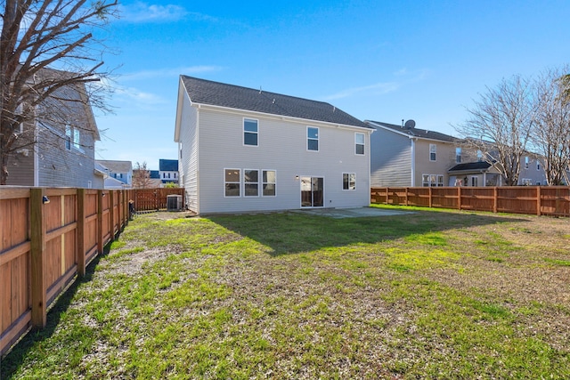 rear view of house with a lawn, cooling unit, and a patio