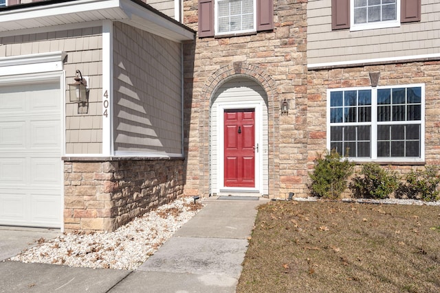 doorway to property with a garage