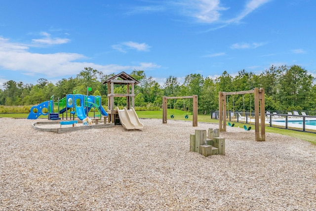 view of jungle gym featuring a swimming pool