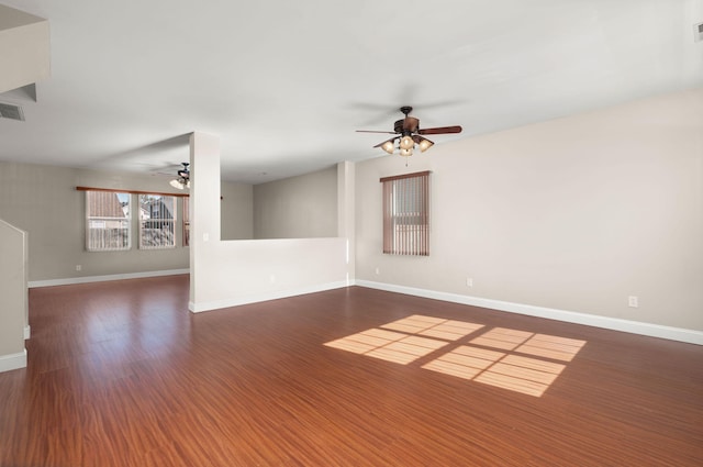 spare room featuring ceiling fan and dark wood-type flooring