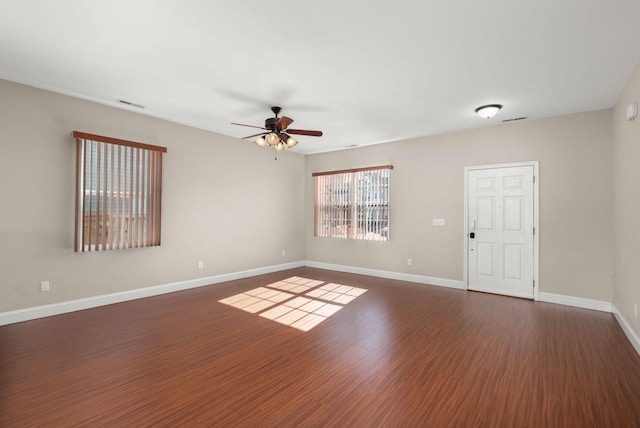 spare room featuring ceiling fan and dark hardwood / wood-style flooring