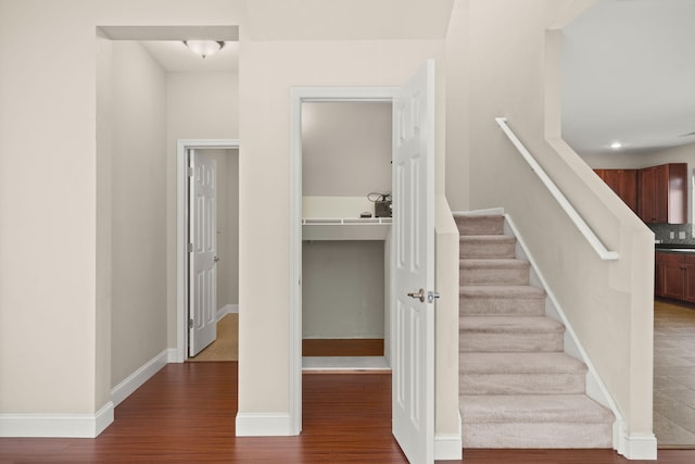 staircase with wood-type flooring