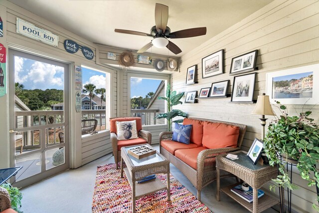 sunroom / solarium featuring ceiling fan