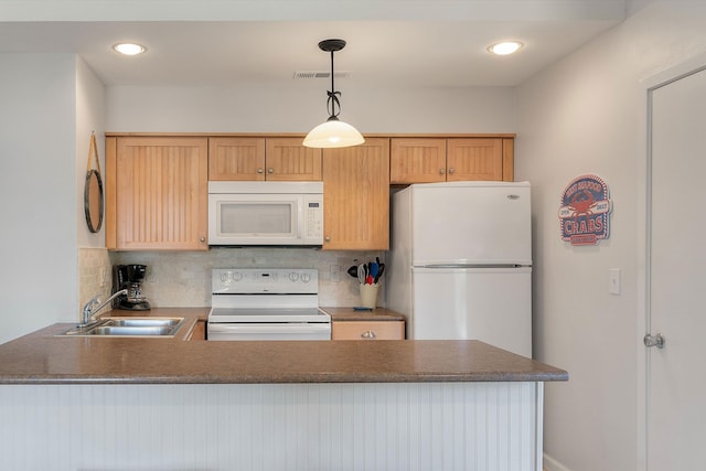 kitchen featuring decorative backsplash, white appliances, sink, kitchen peninsula, and hanging light fixtures