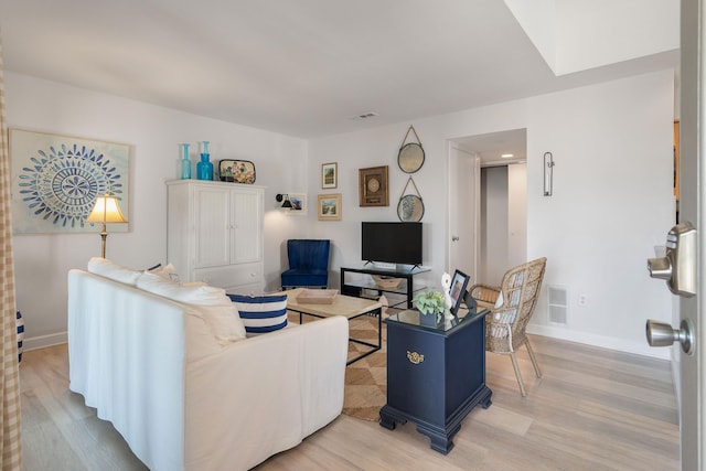 living room with light hardwood / wood-style flooring