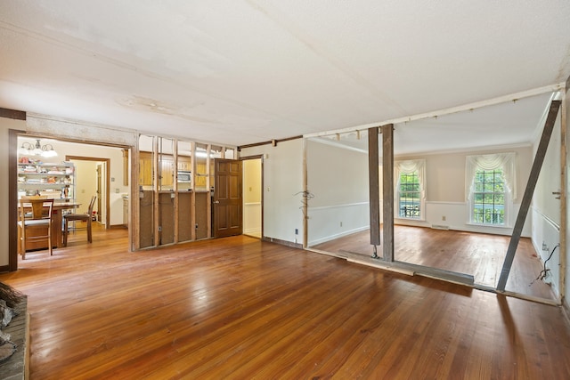 spare room with wood-type flooring and crown molding