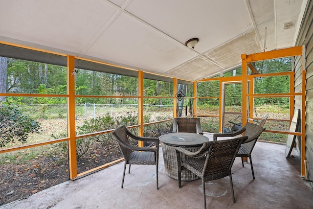 sunroom / solarium featuring vaulted ceiling