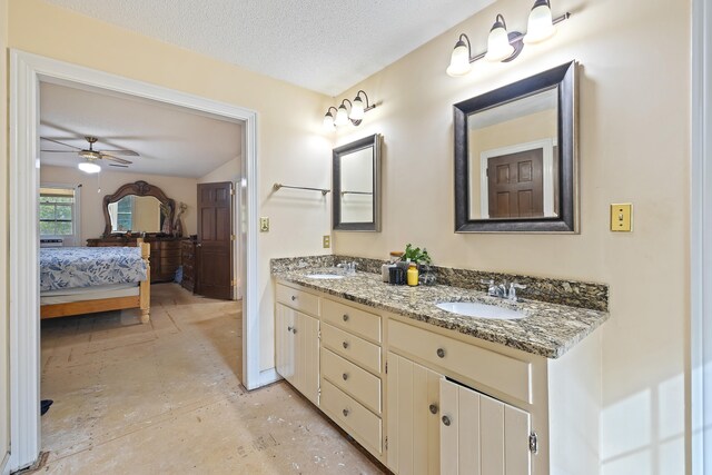 bathroom with dual bowl vanity, a textured ceiling, and ceiling fan