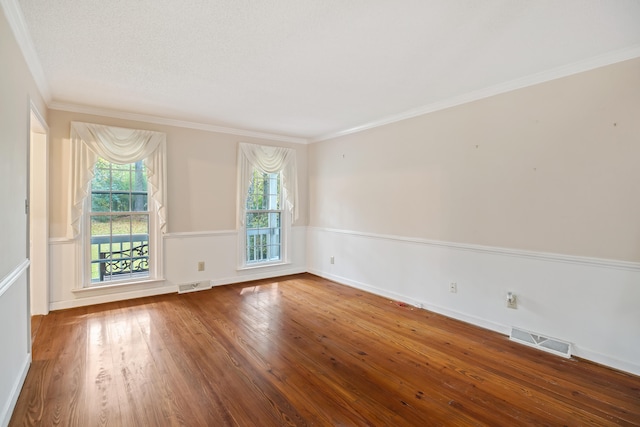 spare room with ornamental molding and wood-type flooring