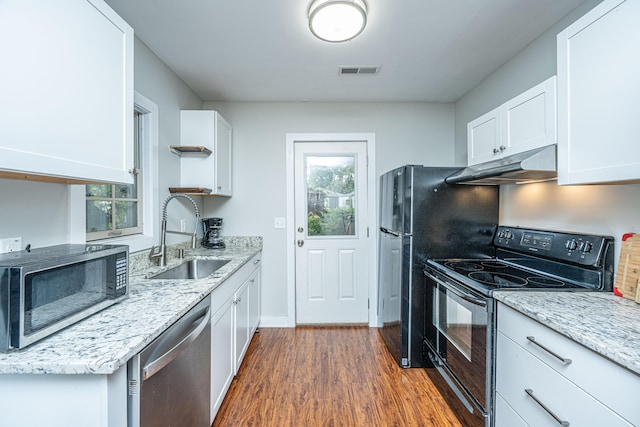 kitchen with white cabinets, light stone counters, stainless steel appliances, sink, and dark hardwood / wood-style floors