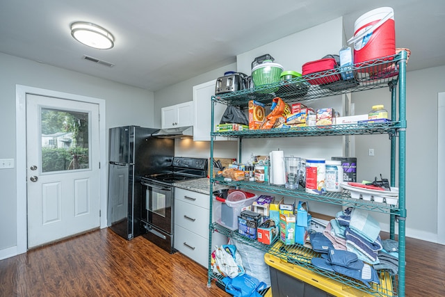 kitchen with black appliances, dark hardwood / wood-style flooring, and white cabinets