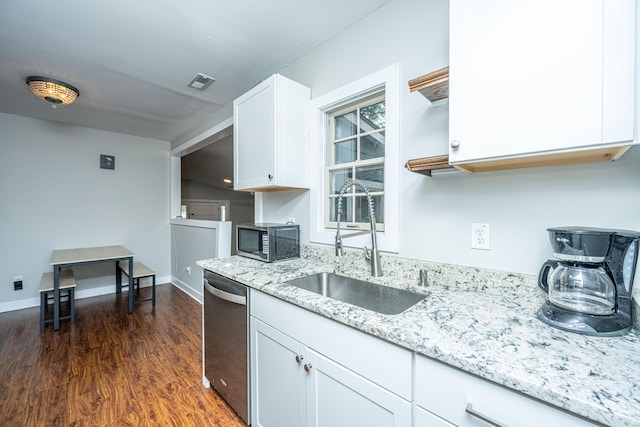 kitchen with dark hardwood / wood-style flooring, sink, light stone countertops, appliances with stainless steel finishes, and white cabinets