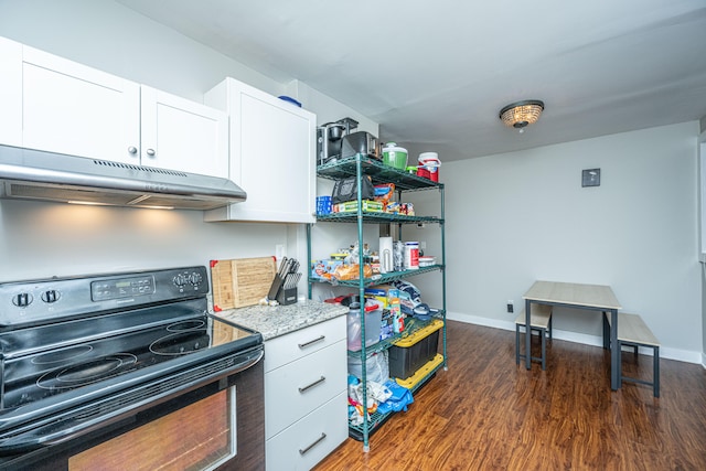 kitchen featuring white cabinetry, black electric range oven, light stone counters, and dark hardwood / wood-style floors