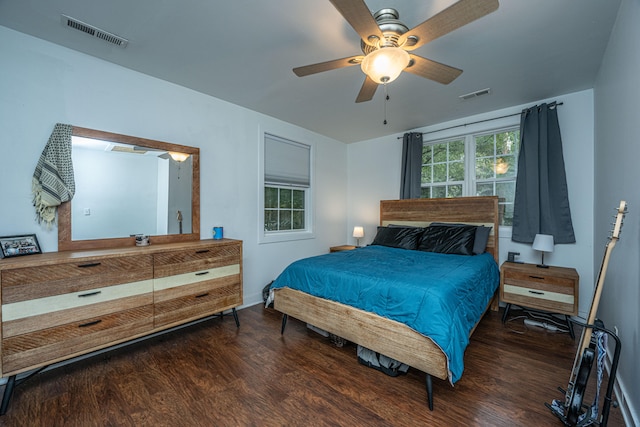 bedroom with ceiling fan and dark hardwood / wood-style floors