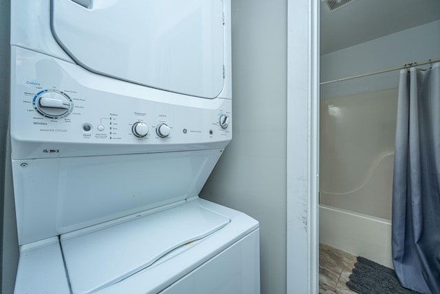 washroom featuring stacked washing maching and dryer