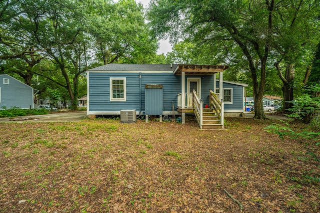 rear view of house with central AC unit